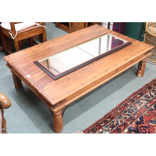 86 - A 20th century mangowood metal bound coffee table on cylindrical supports, 40cm high x 135cm long x ... 