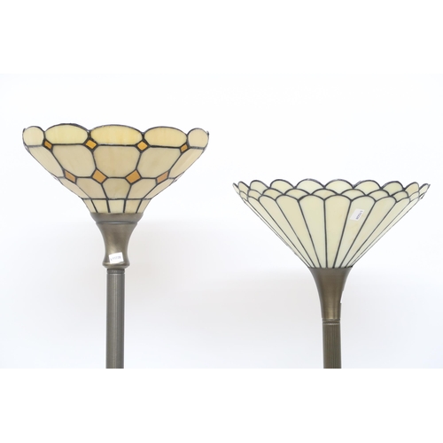 87 - A lot of two assorted metallic based contemporary uplighter standard lamps with tiffany style glass ... 