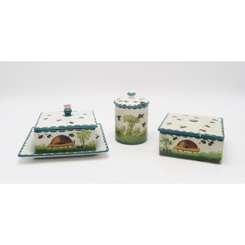 203 - A Wemyss ware honey box and cover with stand, another honey box and cover and a cylindrical honey po... 