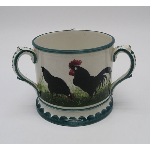 208 - A Wemyss ware black cockerel and hens double inkwell26cm wide, together with a tyg, 10cm high (2)... 