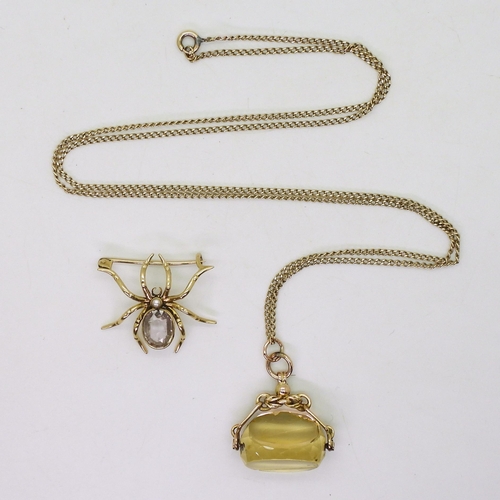 723 - A yellow metal amethyst spider brooch, together with a 9ct gold citrine fob seal (af) and 68cm chain... 