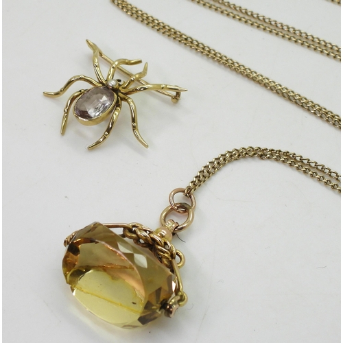 723 - A yellow metal amethyst spider brooch, together with a 9ct gold citrine fob seal (af) and 68cm chain... 