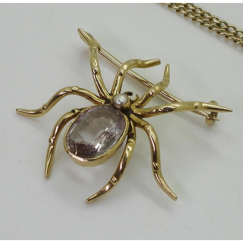 723 - A yellow metal amethyst spider brooch, together with a 9ct gold citrine fob seal (af) and 68cm chain... 