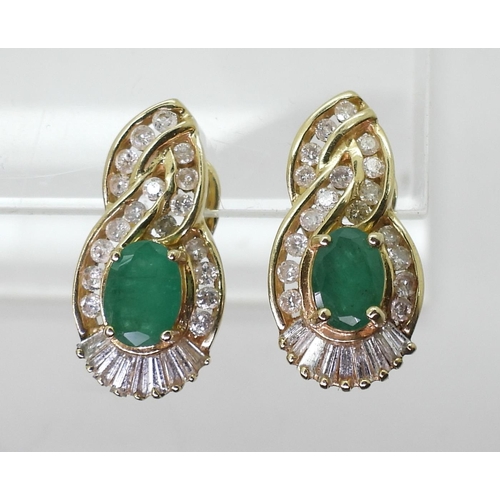 771 - A pair of 14k gold emerald and diamond earrings set with estimated approx 0.50cts of brilliant and b... 