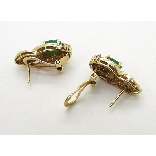 771 - A pair of 14k gold emerald and diamond earrings set with estimated approx 0.50cts of brilliant and b... 