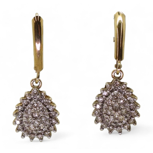 772 - A pair of 10k gold diamond drop earrings with continental hoop closure, set with estimated approx 0.... 