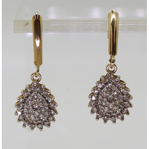 772 - A pair of 10k gold diamond drop earrings with continental hoop closure, set with estimated approx 0.... 