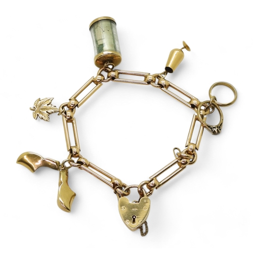 774 - A 9ct gold decorative link charm bracelet with five attached charms, three in 9ct, one in 10k and a ... 