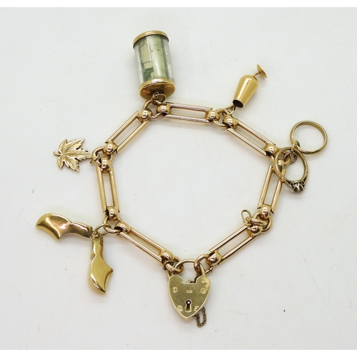 774 - A 9ct gold decorative link charm bracelet with five attached charms, three in 9ct, one in 10k and a ... 