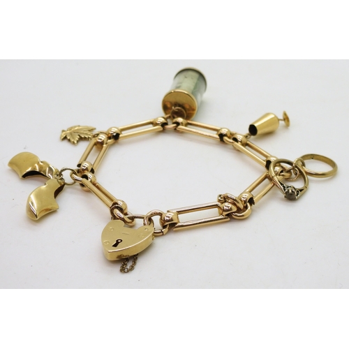 774 - A 9ct gold decorative link charm bracelet with five attached charms, three in 9ct, one in 10k and a ... 