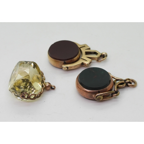 779 - Three 9ct gold mounted fob seals, two set with bloodstone and carnelian and another in citrine, weig... 