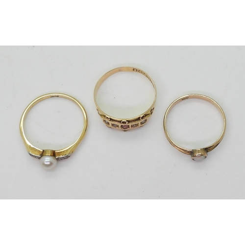 787 - three gold rings, an 18ct gold pearl and diamond ring, size N1/2 1.9gms, 15ct pearl and red gem, siz... 