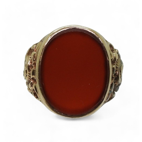 788 - A 9ct gold carnelian signet ring, with flower embossed shoulders, Size W, weight 7.4gms