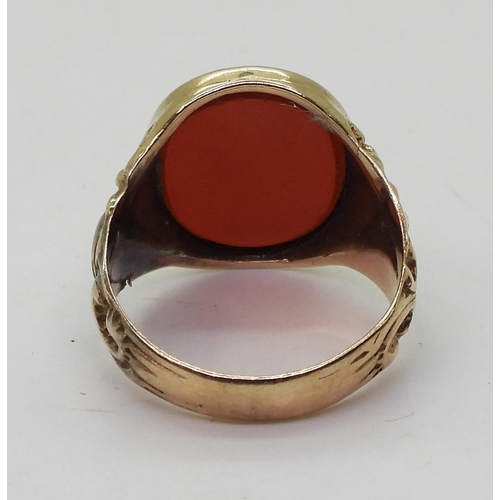 788 - A 9ct gold carnelian signet ring, with flower embossed shoulders, Size W, weight 7.4gms