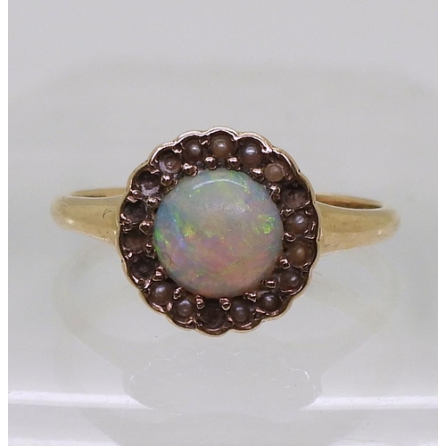 789 - A bright yellow metal ring set with an opal and split pearls (some losses) size O1/2, weight 2.3gms