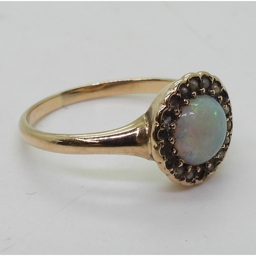 789 - A bright yellow metal ring set with an opal and split pearls (some losses) size O1/2, weight 2.3gms