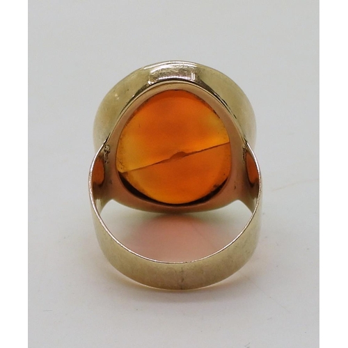 792 - A bright yellow metal signet ring set with a large carnelian intaglio carved with Brittania (cracked... 