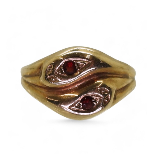 797 - A 9ct gold snake ring the heads set with garnets, hallmarked London 1968, size V1/2, weight 5.9gms