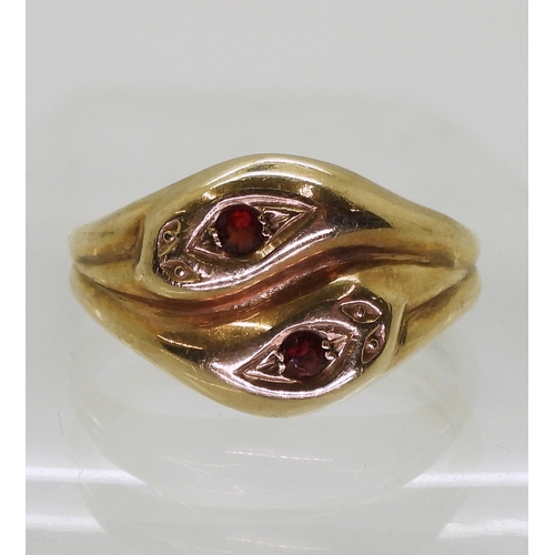 797 - A 9ct gold snake ring the heads set with garnets, hallmarked London 1968, size V1/2, weight 5.9gms