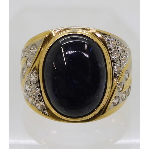 804 - A yellow metal ring set with a star sapphire and clear gems, size S, weight 13.7gms