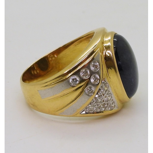 804 - A yellow metal ring set with a star sapphire and clear gems, size S, weight 13.7gms