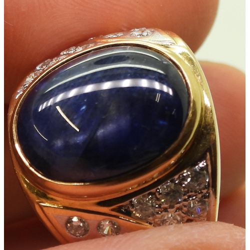 804 - A yellow metal ring set with a star sapphire and clear gems, size S, weight 13.7gms