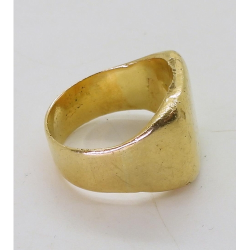 808 - A bright yellow metal signet ring, size R, weight 16.6gms