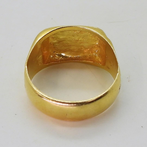 809 - A bright yellow metal signet ring, (stamped 22c) size W, weight 11.8gms