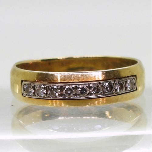 814 - A 14k gold ring set with a band of diamonds with an estimated total of 0.20cts, size u, weight 4.7gm... 