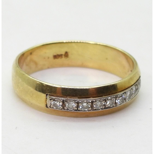 814 - A 14k gold ring set with a band of diamonds with an estimated total of 0.20cts, size u, weight 4.7gm... 