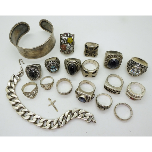 852 - A collection of silver and white metal to include a bangle, curb chain bracelet, American college ri... 