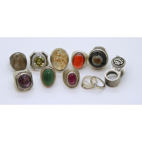 879 - A collection of silver and white metal rings, to include set with ruby, rutilated quartz and agate a... 