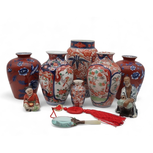 224 - A large collection of Imari vases, plates and chargers, figures, a magnifying glass etc