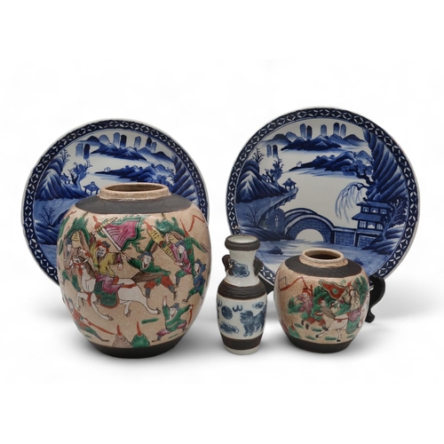 225 - A Nanking 'Warriors' ginger jar, 22cm, a smaller example, 13cm, two Japanese blue and white plates, ... 