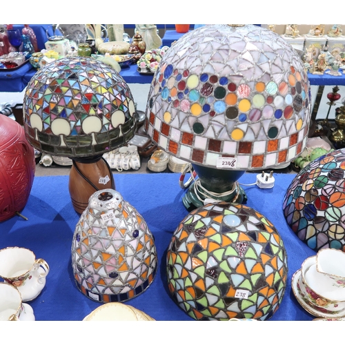 238 - A collection of stained and leaded glass lamp shades, some with bases