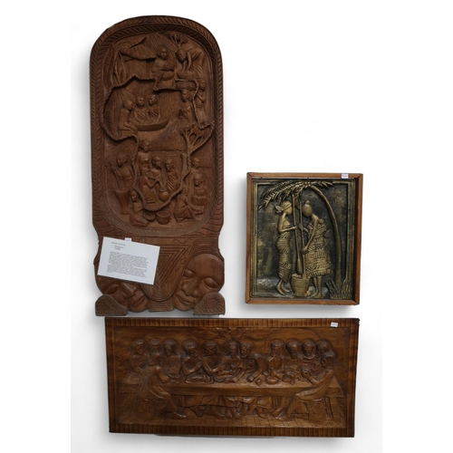 276 - A Ugandan carved mahogany panel depicting village life, together with a gilded carved panel of Afric... 