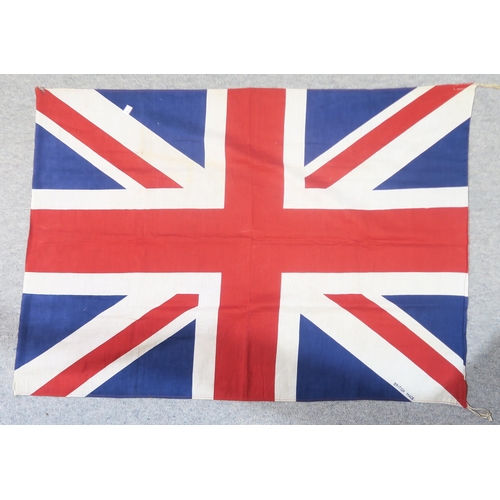 479 - A mid-20th century printed Union Jack, measuring approx. 111cm x 80cm, together with a pair of cast ... 