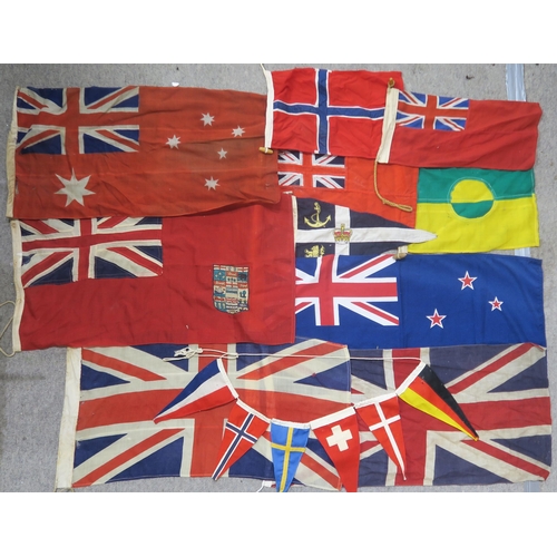 484 - A quantity of assorted maritime flags, to include various British Ensigns, one being mounted on a sh... 