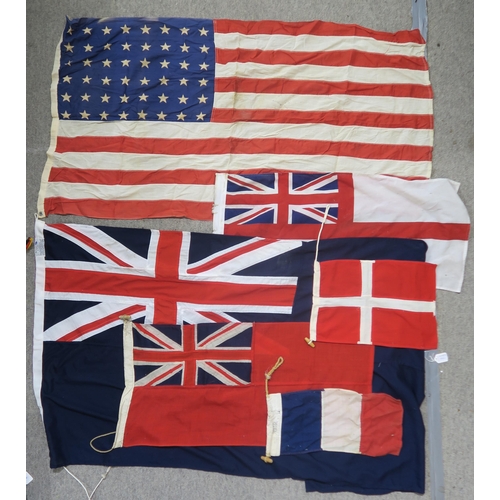 484 - A quantity of assorted maritime flags, to include various British Ensigns, one being mounted on a sh... 