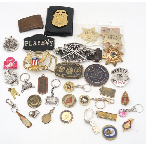 517 - A collection of novelty American sheriff and police badges, Western-style belt buckles etc., contain... 