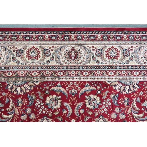 13 - A contemporary Kasbahs by Lano red ground Zeigler style rug with floral/foliate patterned ground wit... 