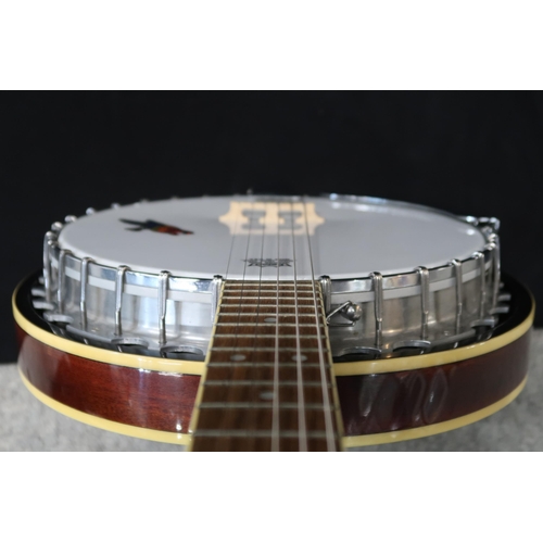 361 - An Ozark six string guitar banjo, 19 frets, with a fitted case and strap