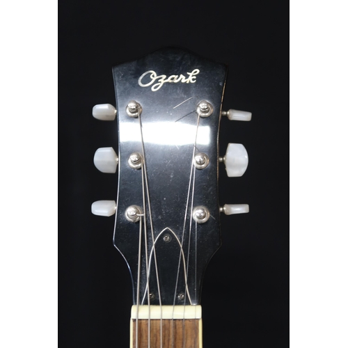 361 - An Ozark six string guitar banjo, 19 frets, with a fitted case and strap