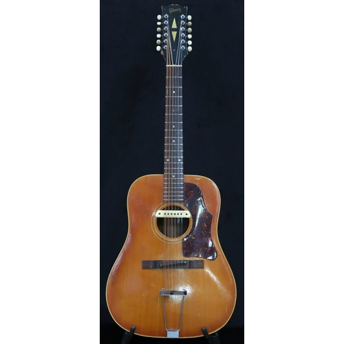 GIBSON A vintage 1960's Gibson B-45 12 string acoustic guitar with natural finish and  tortoise shell scratch plate, serial number 091019, stamped to the interior B-45-12, fitted with a L. R. Baggs pick up  with a Gibson fitted guitar case.