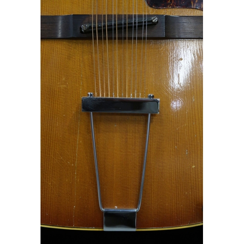 386 - GIBSON A vintage 1960's Gibson B-45 12 string acoustic guitar with natural finish and  tortoise shel... 