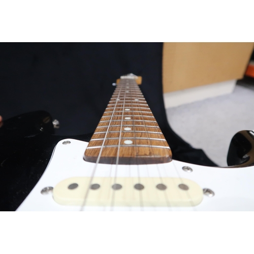 391 - A Fender Stratocaster in black and white scratch plate with a gig bag.This Instrument is from the es... 