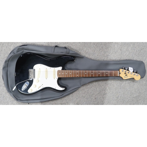 391 - A Fender Stratocaster in black and white scratch plate with a gig bag.This Instrument is from the es... 