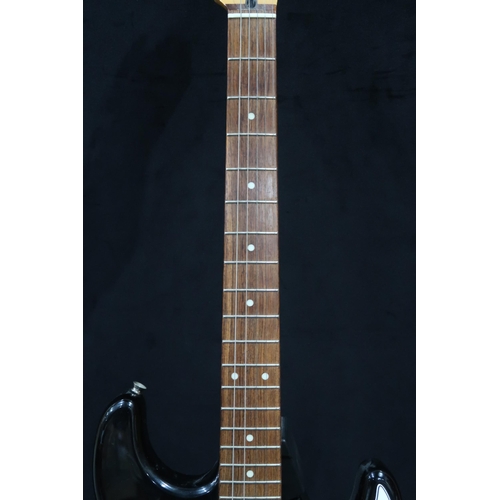 391 - A Fender Stratocaster in black and white scratch plate with a gig bag.This Instrument is from the es... 