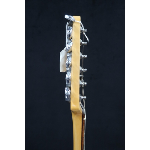 391 - A Fender Stratocaster in black and white scratch plate with a gig bag.This Instrument is from the es... 