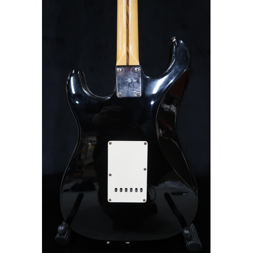 391 - A Fender Stratocaster in black and white scratch plate with a gig bag.This Instrument is from the es... 